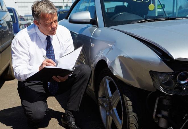 blue car parked with insurance coverage displayed